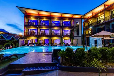 a hotel with a swimming pool in front of a building at Coco Bella Hotel in Phi Phi Don