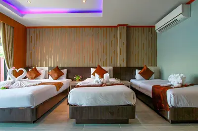 a hotel room with three beds in a room at Coco Bella Hotel in Phi Phi Don