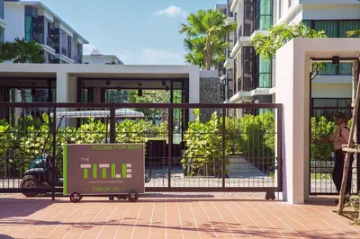 a gate with a sign in front of a building at The Title Condo by Tropiclook in Rawai Beach