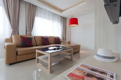a living room with a couch and a table at Coral Inn in Karon Beach