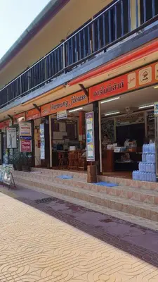 a store front of a building with signs on it at Harmony House-SHA Plus in Phi Phi Don