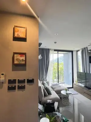 a living room with a couch and a table at Citygate in Kamala beach - Perfect Stay for Digital Work in Kamala Beach