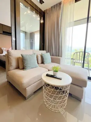 a living room with a couch and a table at Citygate in Kamala beach - Perfect Stay for Digital Work in Kamala Beach