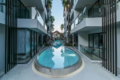 an empty swimming pool in the middle of a building at Modern Condo Palmyrah by Lofty in Surin Beach