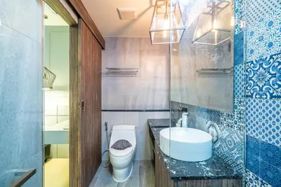 a bathroom with a white toilet and a sink at Modern Condo Palmyrah by Lofty in Surin Beach