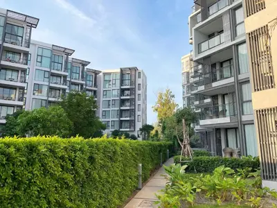 a row of apartment buildings with a hedge at Best location in Laguna-modern apartment at Cassia in Bang Tao Beach