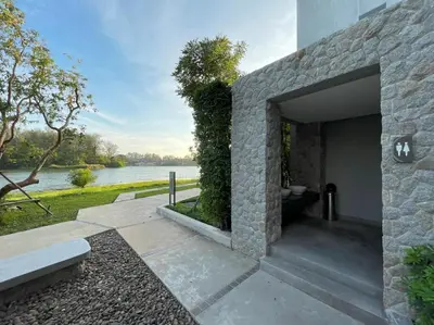 a stone building with a view of a river at Best location in Laguna-modern apartment at Cassia in Bang Tao Beach