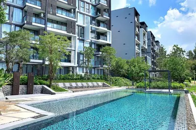 an image of a swimming pool in front of a building at Best location in Laguna-modern apartment at Cassia in Bang Tao Beach