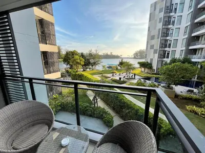 a balcony with chairs and a view of the water at Best location in Laguna-modern apartment at Cassia in Bang Tao Beach