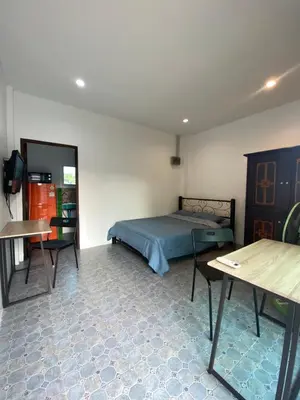 a bedroom with a bed and a table and a desk at Кондо в райском уголке Равай in Rawai Beach
