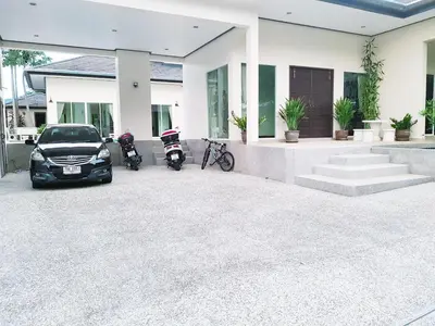 a car parked in front of a house with two scooters at ViewPoint Villa in Kathu