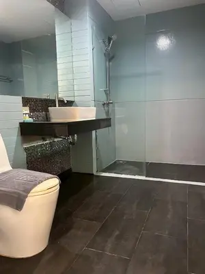 a bathroom with a shower and a toilet and a sink at Coco boutique hotel in Patong Beach