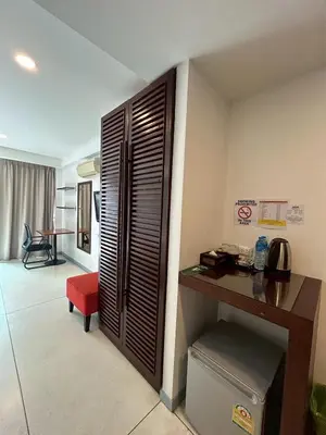 a room with a desk and a room with a table at Coco boutique hotel in Patong Beach