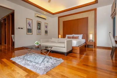 a bedroom with a bed and a table at Villa Autjima krabi /3BRD in Ban Khlong Haeng
