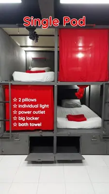a room with three bunk beds with a red sign at Dormsin Chill in Phi Phi Don