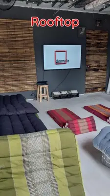 a room with a stage with a television and a bed at Dormsin Chill in Phi Phi Don