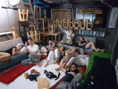 a group of people sitting on the floor in a living room at Dormsin Chill in Phi Phi Don