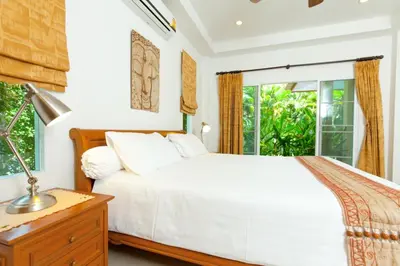 a bedroom with a white bed and a window at Romanee Villa by G Estate in Rawai Beach