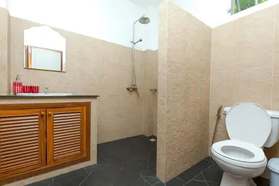 a bathroom with a toilet and a sink at Romanee Villa by G Estate in Rawai Beach