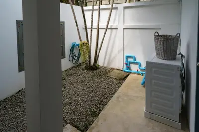 a room with a wall with a gate and a plant at Montaplan Villa by G Estate in Rawai Beach