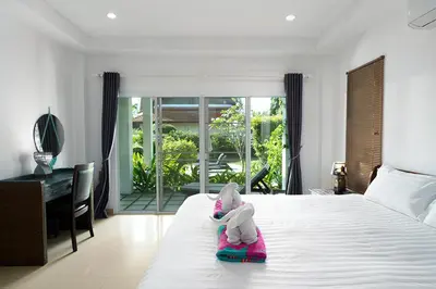 a bedroom with a bed with an elephant toy on it at Montaplan Villa by G Estate in Rawai Beach
