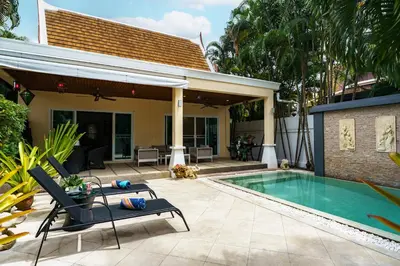 a backyard with a swimming pool and a house at Meursault Villa by G Estate in Rawai Beach