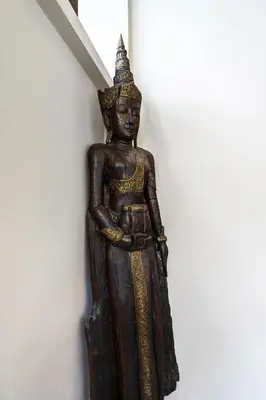 a wooden statue of a deity on a wall at Meursault Villa by G Estate in Rawai Beach