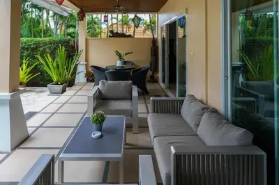 a patio with couches and a table and chairs at Meursault Villa by G Estate in Rawai Beach