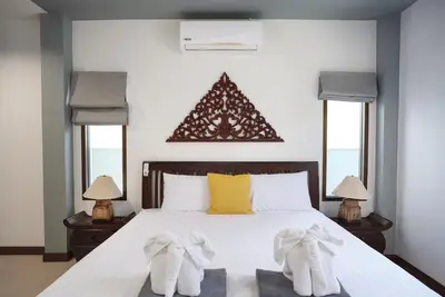 a bedroom with a bed with towels on it at Montrachet Villa by G Estate in Rawai Beach