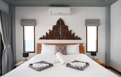 a bedroom with a large bed with two trays on it at Montrachet Villa by G Estate in Rawai Beach