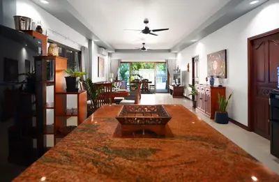 a living room with a large table in the middle at Montrachet Villa by G Estate in Rawai Beach