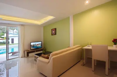 a living room with a couch and a table at The Inspiration Residence in Rawai Beach