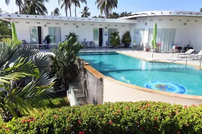a swimming pool in front of a house at The Inspiration Residence in Rawai Beach