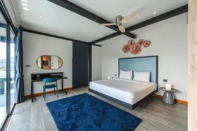 a bedroom with a bed and a desk at Totally New 4BR Private Villa Sunset Garden 2, 12m Oxygen Pool in Rawai Beach