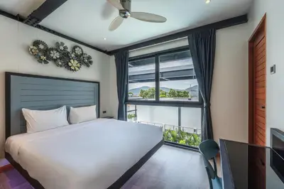 a bedroom with a bed and a large window at Totally New 4BR Private Villa Sunset Garden 2, 12m Oxygen Pool in Rawai Beach