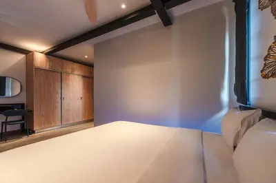 a bedroom with a large white bed and wooden cabinets at Totally New 4BR Private Villa Sunset Garden 2, 12m Oxygen Pool in Rawai Beach