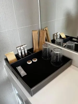 a counter with a mirror and a pile of plates at Aristo Resort Surin Beach M47 in Phuket Town