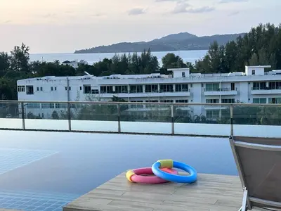 a pool with two inflatables on the edge of a building at Aristo Resort Surin Beach M47 in Phuket Town