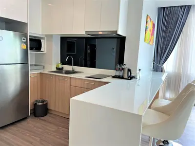 a kitchen with a white counter and a refrigerator at 1 bed Corner apartment in Kata - Grand Kata VIP in Kata Beach