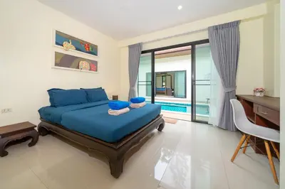 a bedroom with a bed and a desk and a desk at Rawai - 3 BR Private Pool Villa - Phoomjai Villa in Rawai Beach