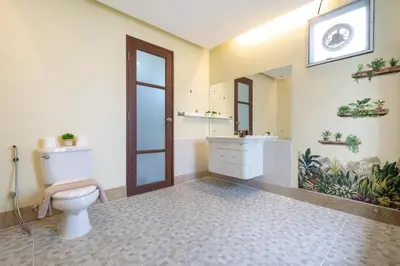 a bathroom with a toilet and a sink and a mirror at Rawai - 3 BR Private Pool Villa - Phoomjai Villa in Rawai Beach