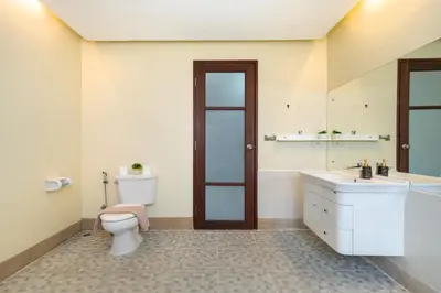 a bathroom with a toilet and a sink at Rawai - 3 BR Private Pool Villa - Phoomjai Villa in Rawai Beach