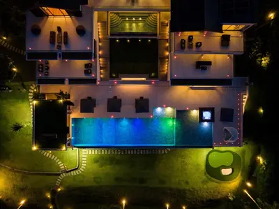 an aerial view of a house with a swimming pool at night at Villa Arun in Phuket Town
