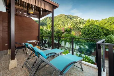 a balcony with chairs and a view of the mountains at Kamala Beach 3-bedroom villa near Fantasea with high-speed Wi-Fi and private pool in Kamala Beach