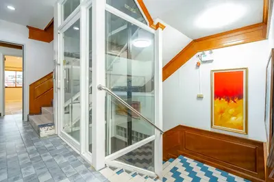 a staircase in a house with glass doors at Patong Social Hotel & Restaurant in Patong Beach