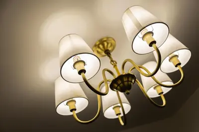 a chandelier with white and gold lights on a wall at Bandalo Boutique Hotel - Patong Beach Road in Patong Beach