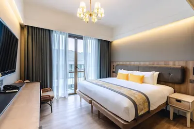 a hotel room with a bed and a chandelier at Bandalo Boutique Hotel - Patong Beach Road in Patong Beach