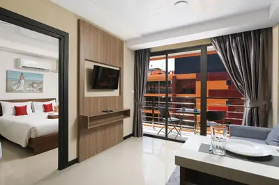 a hotel room with a bed and a balcony at 1bdr apartment NaiHarn Beach condo by Capital Pro in Phuket Town