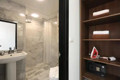 a bathroom with a shower and a sink and a toilet at 1bdr apartment NaiHarn Beach condo by Capital Pro in Phuket Town