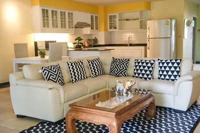 a living room with a couch and a coffee table at Shimmer Three-Bedroom Villa with large garden and two swimming pools in Rawai Beach